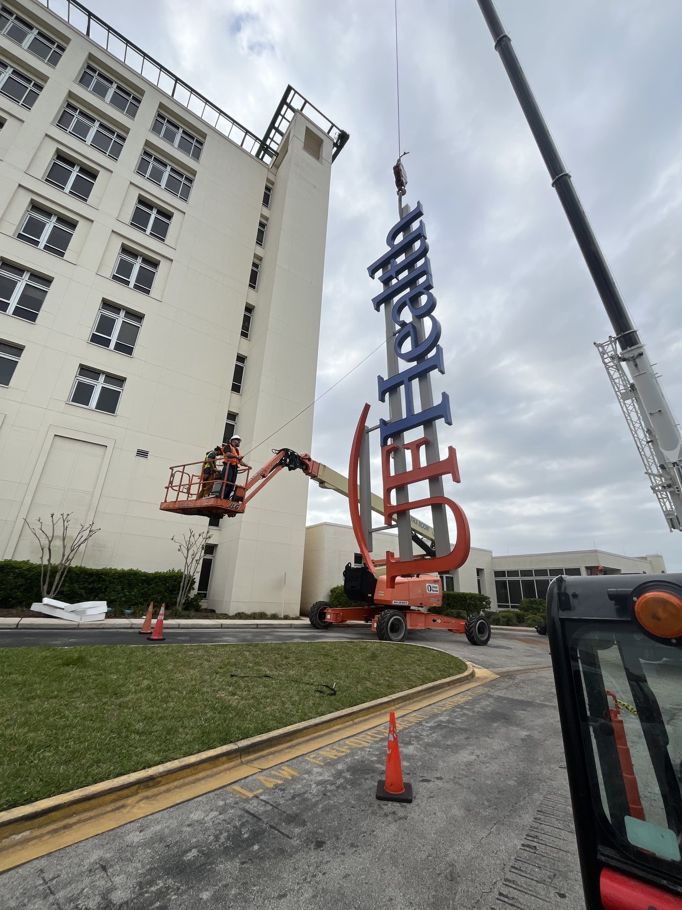 Crane and lift work during high-rise channel letter installation