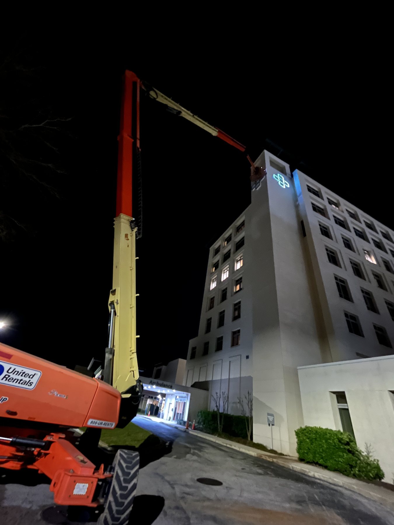 Night crane installation for illuminated hotel signage